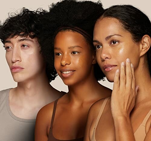 Three people with diverse skin tones looking forward.